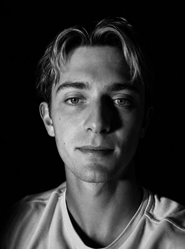 Dramatic black and white close-up with strong side key light