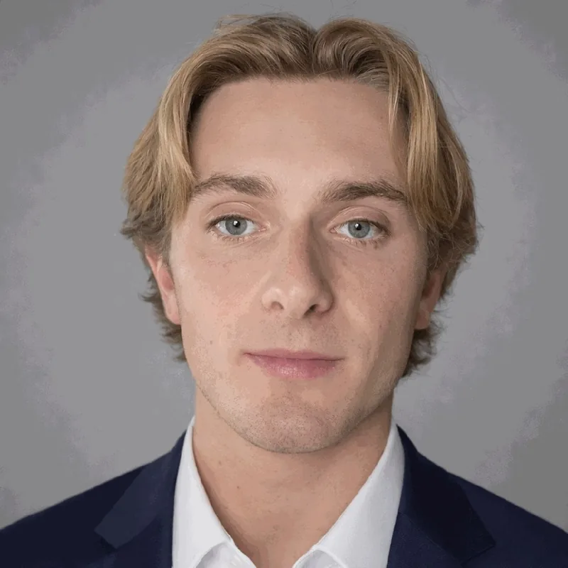 Corporate headshot in a dark suit